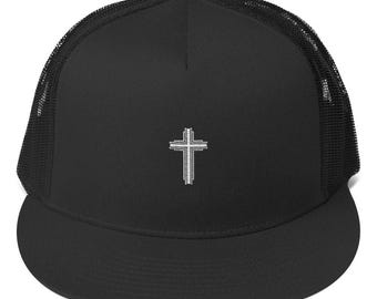 May include: Black trucker hat with a white cross embroidered on the front. The hat has a mesh back.