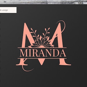 May include: A pink floral monogram with the letter "M" and the name "MIRANDA" underneath. The monogram is on a black background.