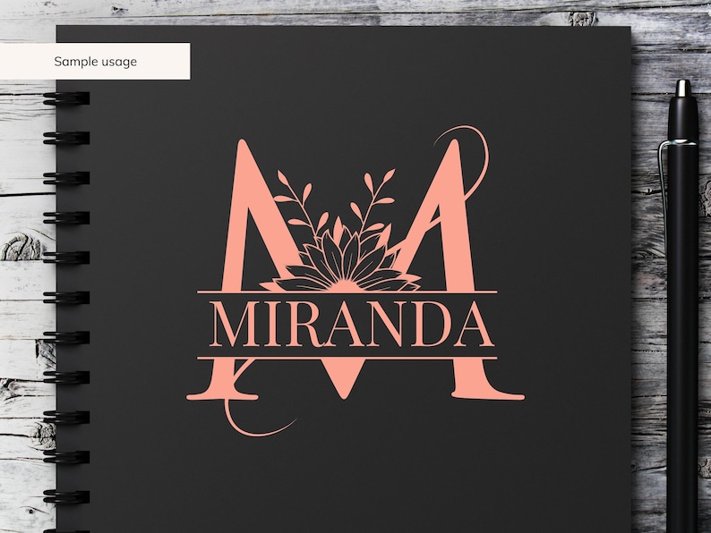 May include: A pink floral monogram with the letter "M" and the name "MIRANDA" underneath. The monogram is on a black background.