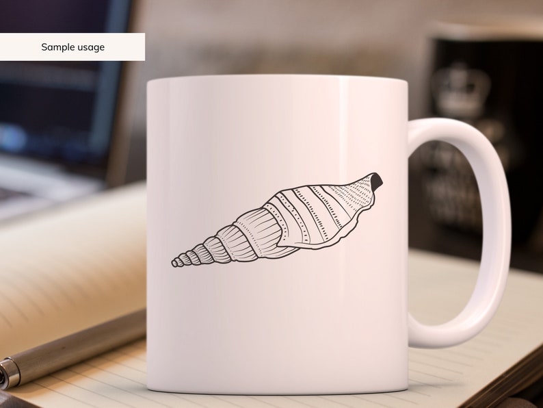 May include: White ceramic mug featuring a black and white illustration of a seashell. The seashell design is detailed with lines and dots. The mug has a curved handle and the text "Sample usage" is in the upper left corner.