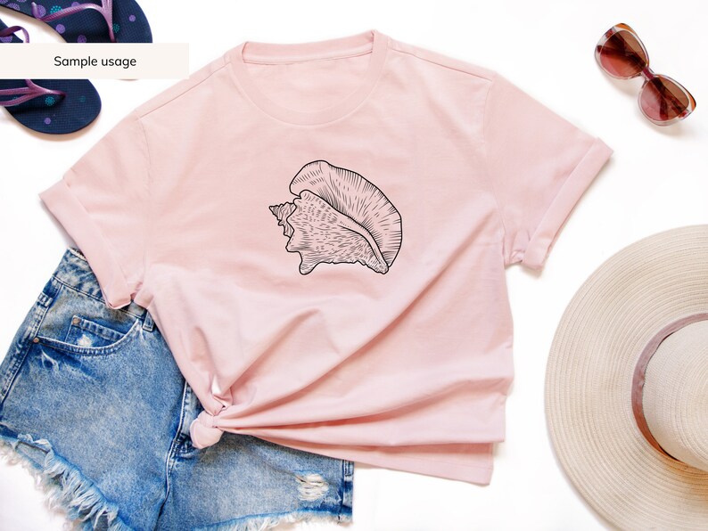 May include: A light pink t-shirt featuring a black seashell graphic. The shirt is styled with denim shorts, sunglasses, a sun hat, and flip-flops. The text "Sample usage" is visible on the image.