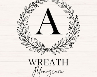 May include: A black letter "A" is centered within a circular wreath of leaves and berries. The words "WREATH Monogram" are below the wreath, with "26 LETTERS" beneath. The design is set against a white wood grain background.