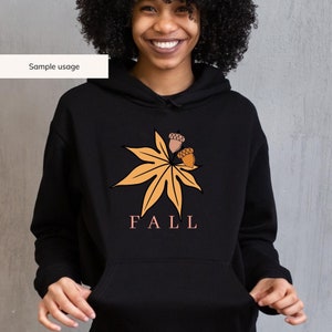 May include: Black hoodie with a graphic of a stylized orange leaf with three acorns and the word "FALL" in pink lettering.