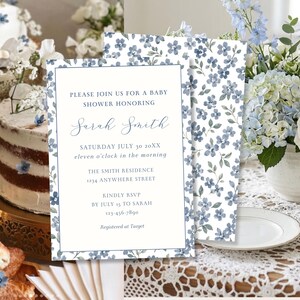 May include: A rectangular baby shower invitation card featuring a blue floral pattern border and white center with text: PLEASE JOIN US FOR A BABY SHOWER HONORING Sarah Smith SATURDAY JULY 30 20XX eleven o'clock in the morning THE SMITH RESIDENCE 1234 ANYWHERE STREET KINDLY RSVP BY JULY 15 TO SARAH 123-456-7890 Registered at Target.