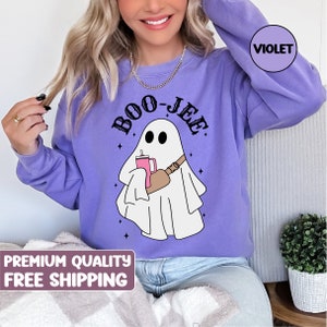 May include: Purple sweatshirt featuring a white ghost holding a pink drink and the text "BOO-JEE" in black.