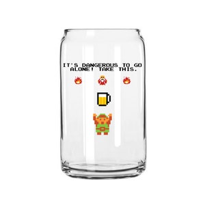 May include: A clear glass can with a pixelated image of a video game character holding a beer. The text on the can reads "It's dangerous to go alone! Take this."