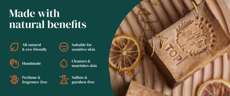 May include: A close-up of a brown bar of soap with the word "TOP" embossed on it. The soap is made with natural ingredients and is free of sulfates and parabens. It is suitable for sensitive skin.