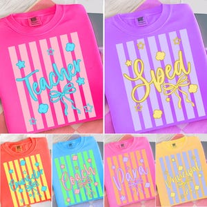 May include: A selection of crew neck sweatshirts in different colours, each with a vertical striped design, a bow, and text. The text on the sweatshirts reads "Teacher", "Sped", "Counselor", "Coach", "Para", and "Principal".