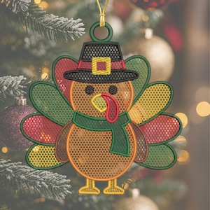 May include: Embroidered turkey ornament with a pilgrim hat, green scarf, and colorful tail feathers. The Thanksgiving decoration has a gold hanging loop and is set against a blurred background of Christmas ornaments and greenery.