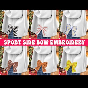 May include: Six white sweatshirts with different colored embroidered bows on the back. The bows are designed with various sports themes, including baseball, basketball, softball, and soccer.