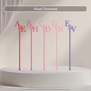 May include: Five thin, vertical cake toppers featuring letter pairs connected by an ampersand. The pairs are A&E in red, B&H in magenta, C&D in pink, D&N in light pink, and E&V in purple. Each topper has a long, slender stem.