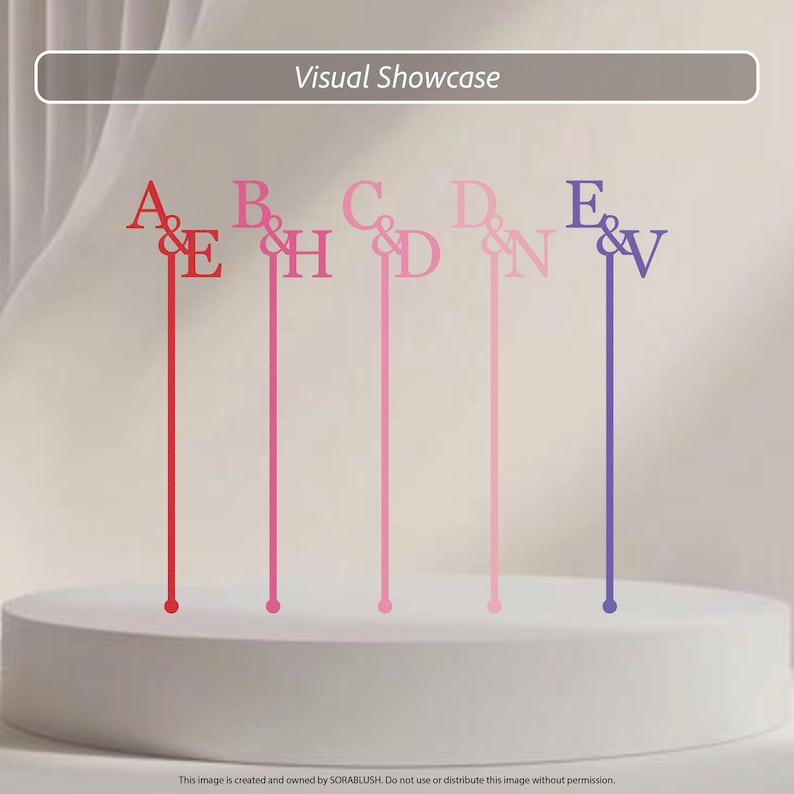 May include: Five thin, vertical cake toppers featuring letter pairs connected by an ampersand. The pairs are A&E in red, B&H in magenta, C&D in pink, D&N in light pink, and E&V in purple. Each topper has a long, slender stem.