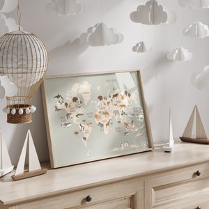 May include: A framed world map print with illustrations of animals from different continents. The map is on a light wood dresser with white paper clouds hanging from the ceiling.