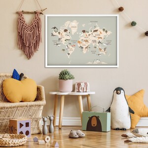 May include: A light blue world map with illustrations of animals from different continents. The map is framed in white and hanging on a light beige wall. The map is surrounded by various children's toys, including a stuffed giraffe, a stuffed penguin, and a wicker chair.