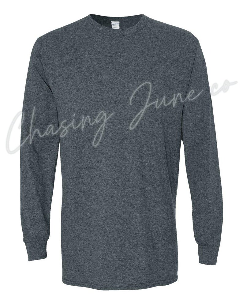 May include: Dark grey long-sleeved shirt with a crew neck and ribbed cuffs. The text "Chasing June co" is written in a cursive font across the front of the shirt.