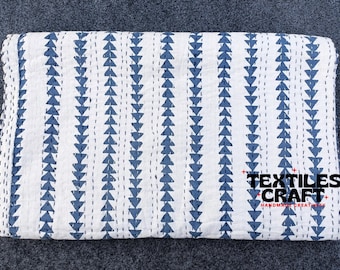 May include: White cotton quilt with a blue triangle pattern and a blue stripe design. The quilt has a "Textiles Craft" label with the text "Handmade Creativity".