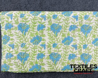 May include: White cotton fabric with a blue and green floral print. The fabric is quilted and has a hand-stitched look. The fabric is labeled "Textiles Craft Handmade Creativity".