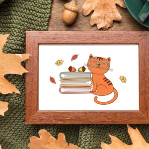 May include: A framed illustration of a cat wearing glasses and sitting on a stack of books. The cat is orange and white with a red nose. The books are brown and yellow. The background is white with a few scattered leaves.