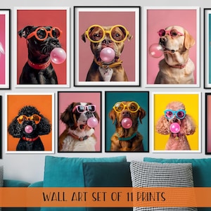 May include: A collection of eleven framed wall art prints. Each print features a dog wearing sunglasses and blowing a bubble gum bubble. The dogs are set against various colourful backgrounds. The prints are displayed above a blue sofa.