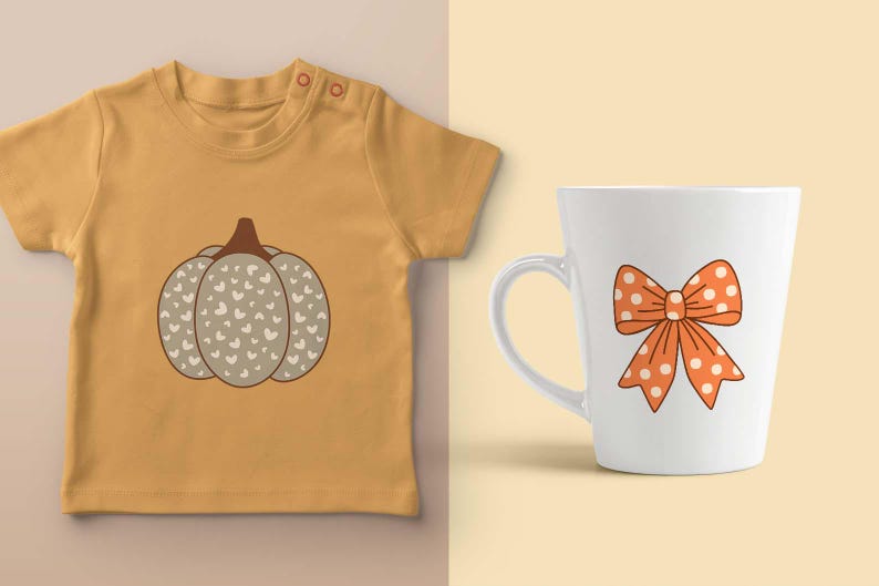 May include: Mustard yellow baby tee with a pumpkin graphic. The pumpkin is gray with white heart details and a brown stem. A white mug with an orange bow with white polka dots is also shown.