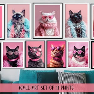 May include: A collection of eleven framed cat portraits. Each cat is depicted wearing sunglasses and stylish accessories such as faux fur and jewellery. The background is a solid pink. The text at the bottom reads "WALL ART SET OF 11 PRINTS."