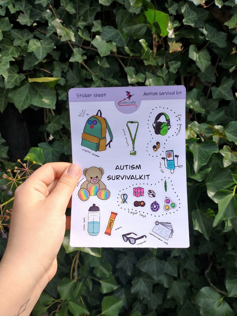 May include: A sticker sheet with an autism survival kit theme. The sheet includes a backpack, headphones, a fidget toy, a water bottle, a snack bar, sunglasses, a teddy bear, a sensory toy, and a communication card that says "YES".