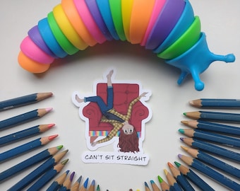 May include: A sticker with a cartoon illustration of a person sitting on a couch with the text "Can't Sit Straight". The sticker is surrounded by a circle of colored pencils with blue barrels.