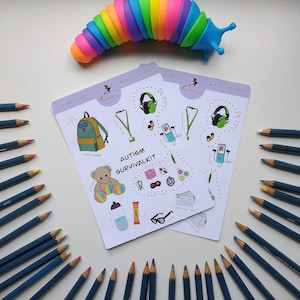 May include: A set of two sticker sheets with colorful illustrations of items that can be helpful for people with autism. The sticker sheets are titled "Autism Survival Kit" and "Sticker Sheet". The sheets are surrounded by a circle of colored pencils.
