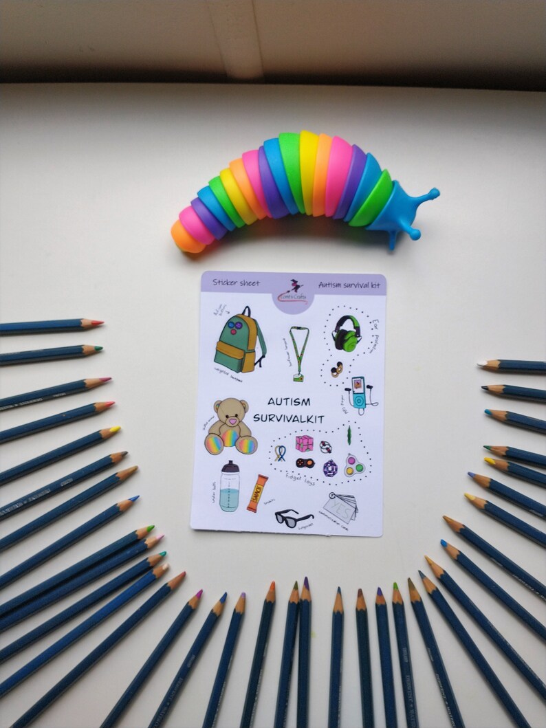 May include: A sticker sheet with a colorful backpack, a fidget toy, noise-canceling headphones, a water bottle, a granola bar, a teddy bear, and other items. The sticker sheet is titled "Autism Survival Kit".