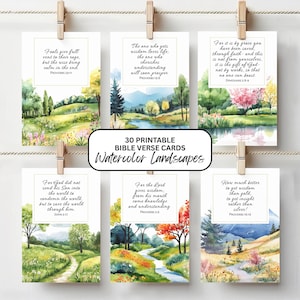 May include: A collection of 30 printable Bible verse cards featuring watercolor landscape art. Each card displays a different verse with a corresponding scenic illustration. The cards are held by wooden clothespins.