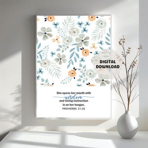 May include: A framed print with a floral design in shades of blue, peach, and white. The print features the text "She opens her mouth with wisdom and loving instruction is on her tongue. PROVERBS 31:26" and "DIGITAL DOWNLOAD".