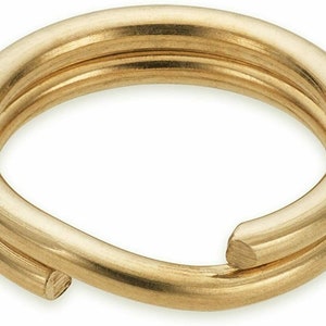 May include: A gold-coloured metal jump ring, also known as a key ring, is a circular ring with a gap for attaching items. It is a common jewellery finding used for making necklaces, bracelets, and keychains.