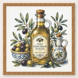 May include: A framed cross-stitch embroidery featuring a glass bottle of golden olive oil with a cork stopper, labeled OLIO EXTRA VERGINE DI OLIVA 100% ITALIANO. Beside it sits a ceramic bowl filled with green and black olives and a decorative pitcher.