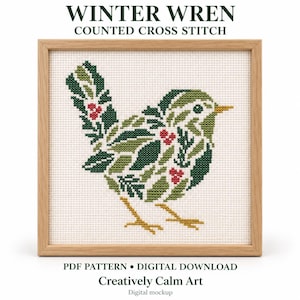 May include: A counted cross stitch pattern titled WINTER WREN featuring a bird composed of green leaves and red berries. The design is displayed in a light wood frame on a white background with text reading PDF PATTERN DIGITAL DOWNLOAD.