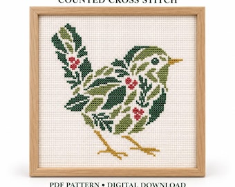 May include: A counted cross stitch pattern titled WINTER WREN featuring a bird composed of green leaves and red berries. The design is displayed in a light wood frame on a white background with text reading PDF PATTERN DIGITAL DOWNLOAD.