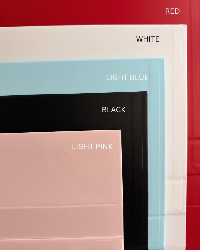 May include: A stack of rectangular boxes in various colors, including red, white, light blue, black, and light pink. Each box is labeled with its corresponding color name in white text, providing a clear visual guide to the available color options.