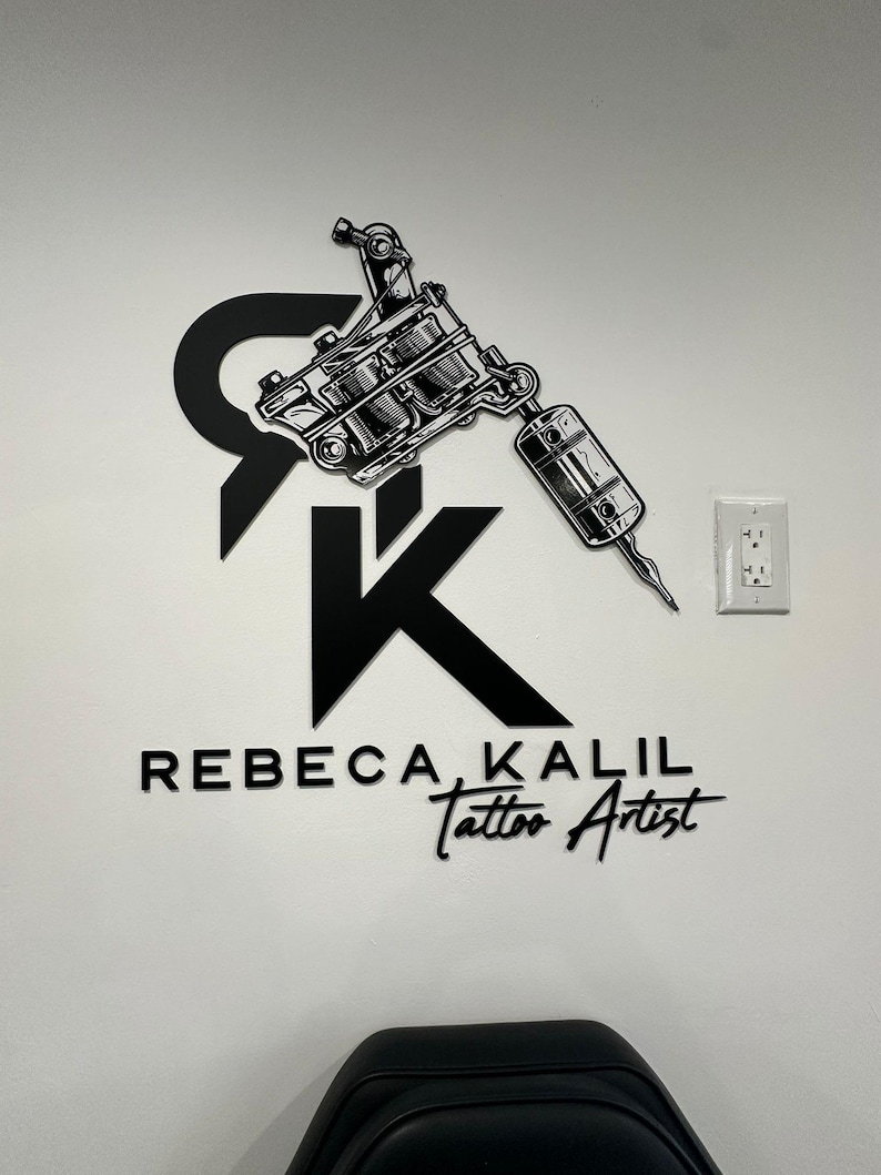 May include: Black and white logo for a tattoo artist named Rebecca Kalil. The logo features a stylized tattoo machine and the letters "RK" in a bold font.