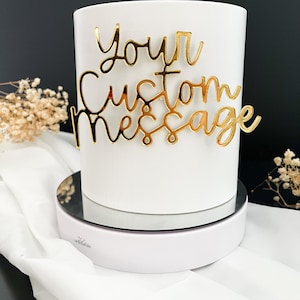 May include: White ceramic mug with a gold metallic decal that says "Your Custom Message".