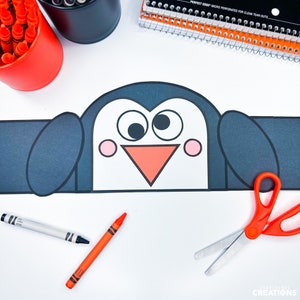 May include: A black and white penguin craft template with large eyes, a red beak, and pink cheeks. The template is ready to be cut out and coloured with crayons or markers.
