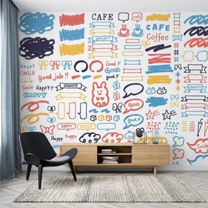 May include: A wall mural featuring a collection of colorful hand-drawn doodles, including speech bubbles, ribbons, stars, bows, and text such as CAFE, Coffee, Happy, and Smile. The design uses a palette of red, blue, yellow, and black on a white background.