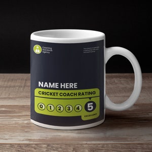 May include: White ceramic mug with a black and green design. The mug features the text "NAME HERE" and "CRICKET COACH RATING" with a rating scale from 0 to 5. The number 5 is highlighted in green and the text "EXCELLENT" is below it.