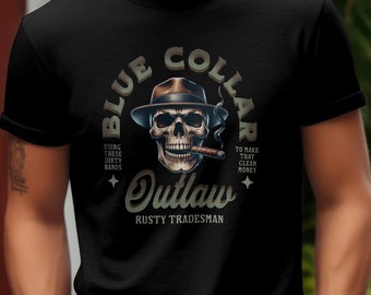 May include: Black t-shirt featuring a skull wearing a hat and smoking a cigar. The design includes the words "BLUE COLLAR OUTLAW" and "RUSTY TRADESMAN". The shirt's graphic also includes the phrases "USING THESE DIRTY HANDS" and "TO MAKE THAT CLEAN MONEY".