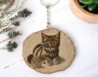Playing baby cat. Handmade and natural one-of-a-kind keychain made of wood
