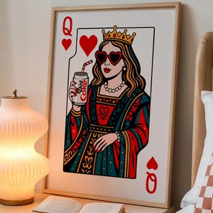 May include: A framed wall art print featuring a stylized Queen of Hearts playing card illustration. The queen wears a crown, heart-shaped sunglasses, and a red and teal gown, while holding a silver can labeled Diet Coke with a striped straw.