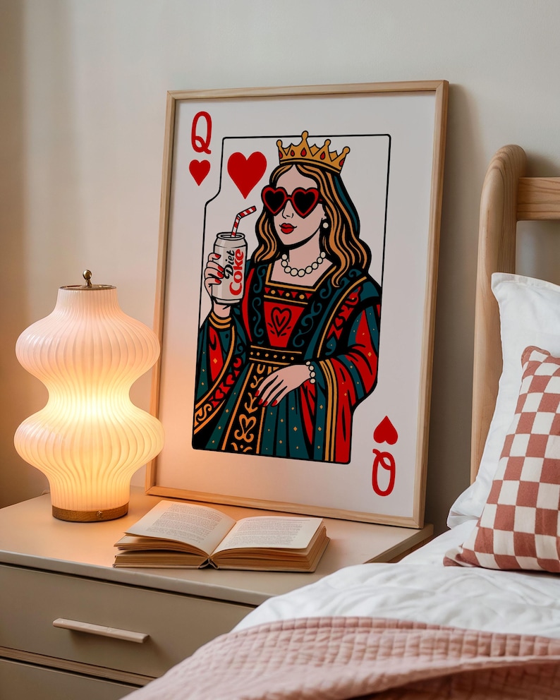 May include: A framed wall art print featuring a stylized Queen of Hearts playing card illustration. The queen wears a crown, heart-shaped sunglasses, and a red and teal gown, while holding a silver can labeled Diet Coke with a striped straw.