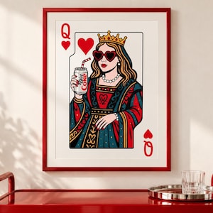 May include: A framed wall art print featuring a stylized Queen of Hearts playing card illustration. The queen wears a gold crown, heart-shaped sunglasses, and a pearl necklace while holding a silver can labeled Diet Coke with a red striped straw.