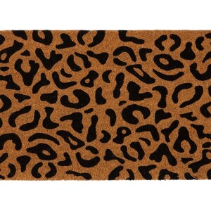 May include: A brown coir doormat with a black leopard print design.