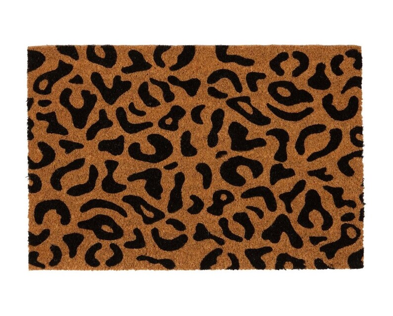 May include: A brown coir doormat with a black leopard print design.