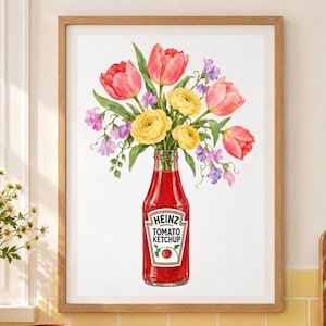 May include: A framed watercolor print featuring a glass Heinz Tomato Ketchup bottle used as a vase. The bottle is filled with a vibrant bouquet of pink tulips, yellow ranunculus, and small purple flowers against a plain white background.