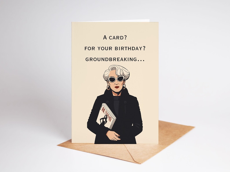 Puede incluir: Una tarjeta de felicitaci&oacute;n con el texto "A card? For your birthday? Groundbreaking..." sobre un fondo beige. La tarjeta presenta una ilustraci&oacute;n de una mujer con gafas de sol y un abrigo negro, sosteniendo una revista. La tarjeta est&aacute; sobre un sobre marr&oacute;n.